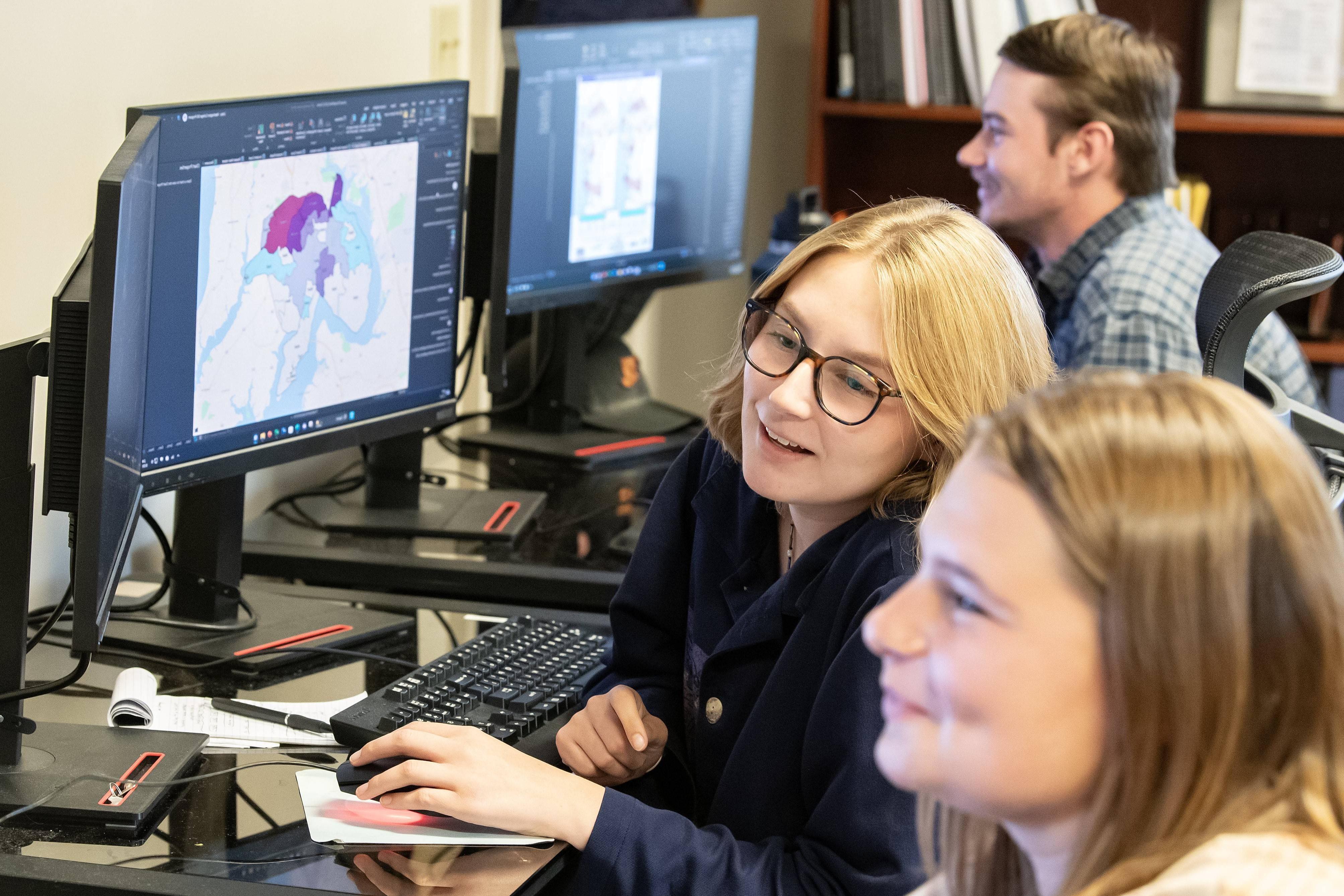 Students looking at GIS data on a computer